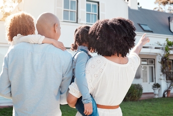 african american family outside new home