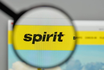 A magnifying glass hovering over the Spirit Airlines logo on the website homepage.