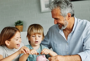 A grandparent teaching his grandkids how to save