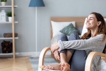 Woman relaxing in cozy chair