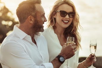 Happy couple having white wine outdoors