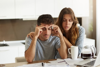 couple stressing at utility bills 