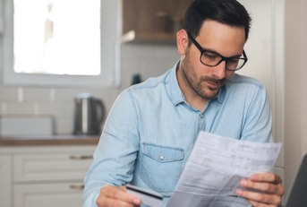 man thinking to pay utility bills