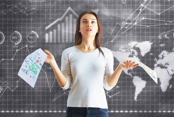 woman besides board with finance charts