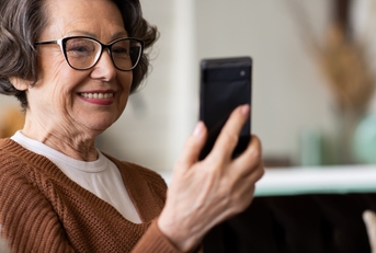 senior woman video calling using smartphone