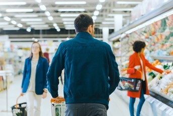 man pushing shopping cart