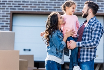 happy family outside new house