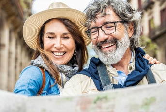 senior couple reviewing map while traveling