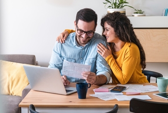 happy couple paying bills online