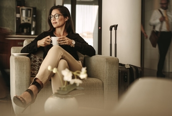 businesswoman having coffee at airport lounge