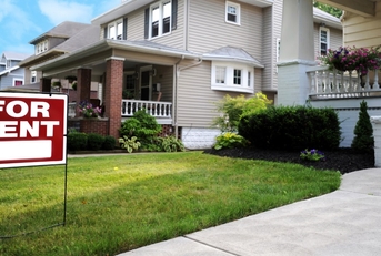 for rent sign outside beautiful mansion