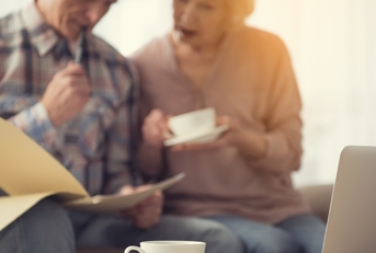 senior couple checking documents at tea