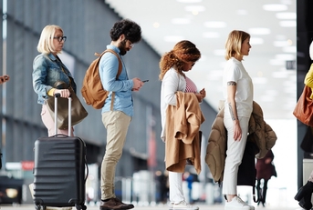 multi ethnic people waiting at airport