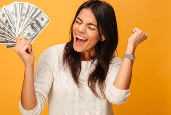 cheerful young woman holding money