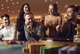 cheerful people betting at roulette poker 
