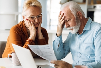 worried senior couple feeling stressed