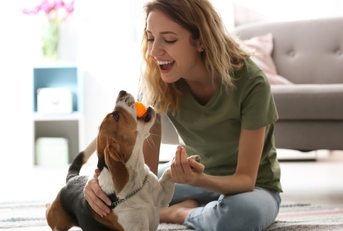 young woman playing with her dog