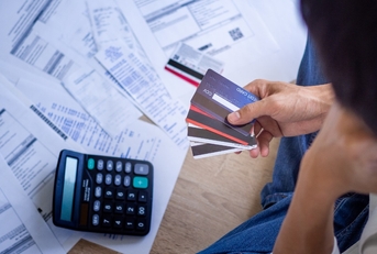 stressed businessman choosing card for bills