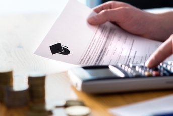 man calculating college fees using calculator