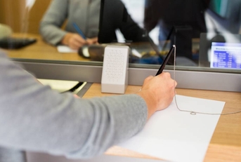 A customer filling out an application at a bank. 