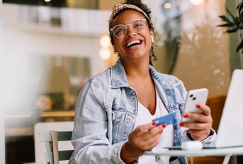 Smiling woman using a credit card