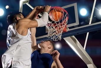basketball players shooting goal