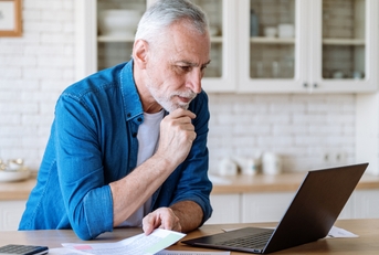 mature man looking at laptop