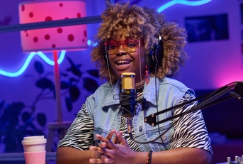 A woman recording a podcast episode