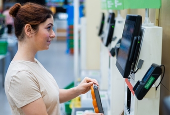 woman using self-checkout counter