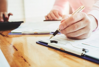 man signing documents at office
