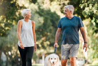 couple walking with dog