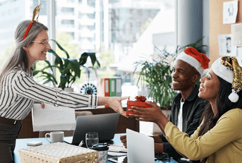 People getting holiday gifts from a boss at the office
