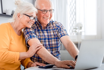 senior couple checking bills