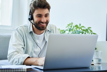 man with headset telecommuting