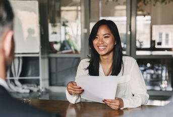 asian woman giving resume to managers