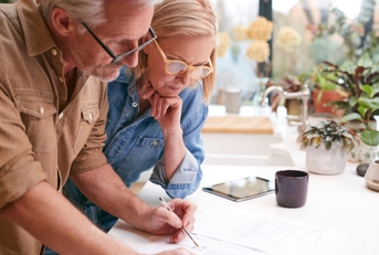 mature couple signing paperwork