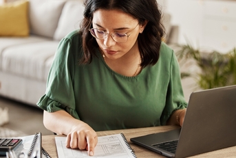 woman preparing budget using laptop