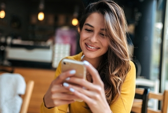 Smiling woman looking at phone