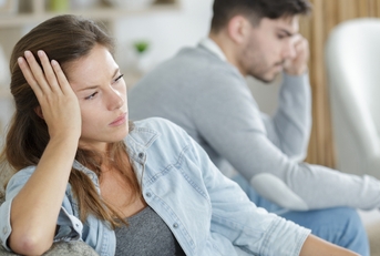 a couple is sitting separately