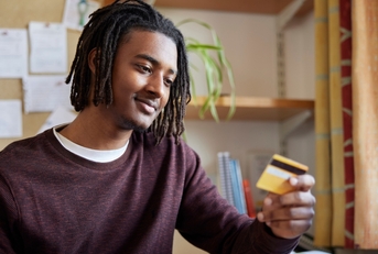 College student looking at credit card