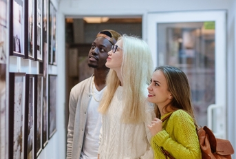 multi ethnic friends at art gallery