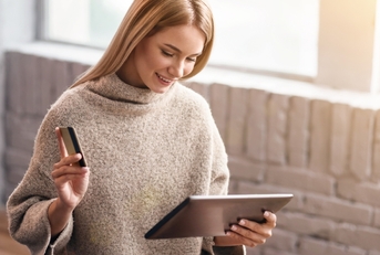 A woman shopping online with a credit card