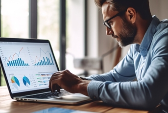 businessman reviewing data on laptop
