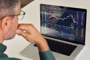 male investor reviewing crypto graphs