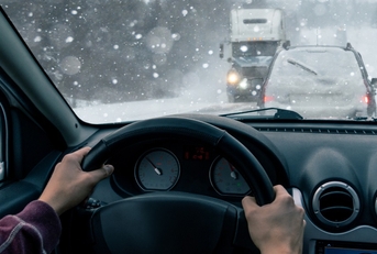 man driving car on snowy road