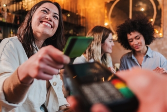 woman paying using card at restaurant