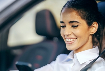 happy woman driving a car