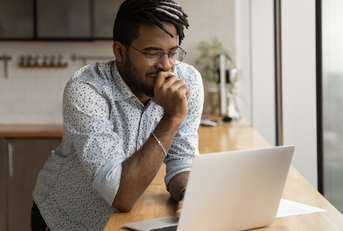 freelancer stands at kitchen desk