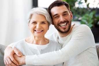 son smiling with mother at home