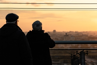 elderly couple watching sunset